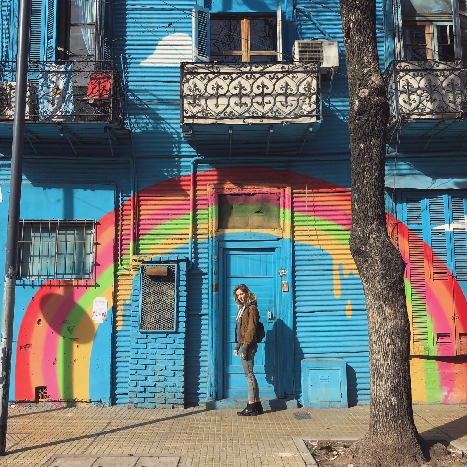 Murale arcobaleno su una casa azzurra in via Wenceslao Villafañe a La Boca, Buenos Aires