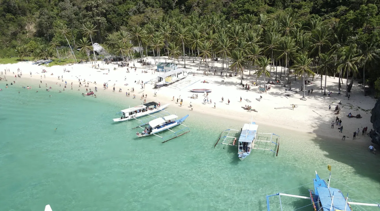 Seven Commandos Beach a El Nido vista dall'alto, con barche tradizionali e mare turchese