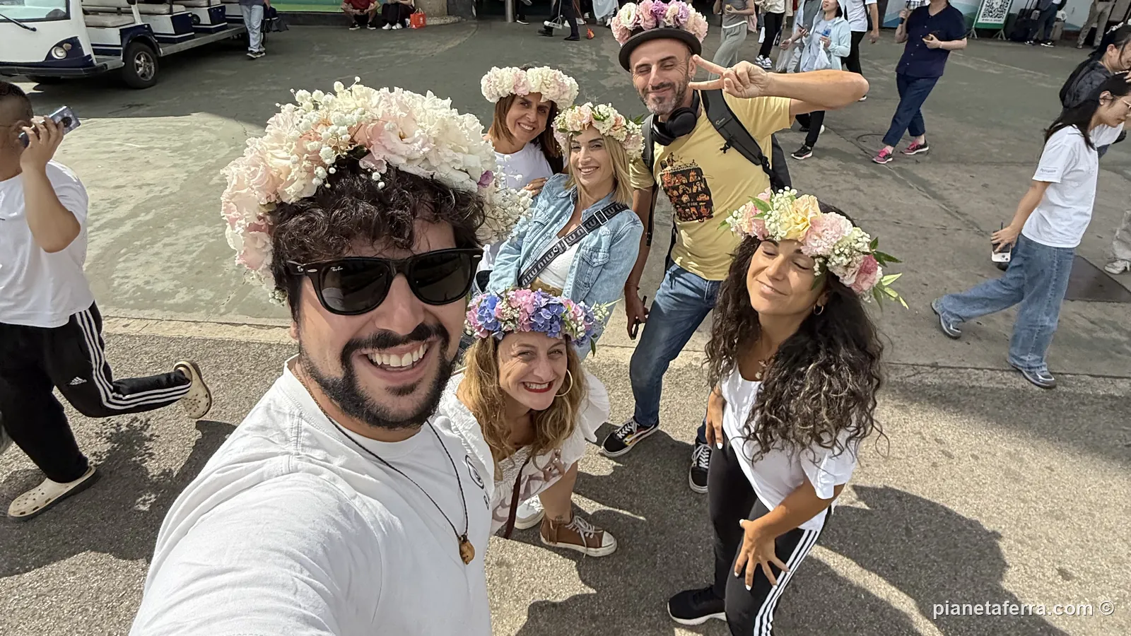 Luca e il gruppo con le corone di fiori davanti al mercato di Dounan