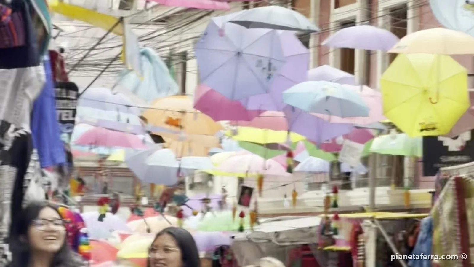 Le vie del centro di La Paz intorno a calle Sagárnaga, con gli ombrelli colorati appesi sopra la strada e i negozi di tessuti